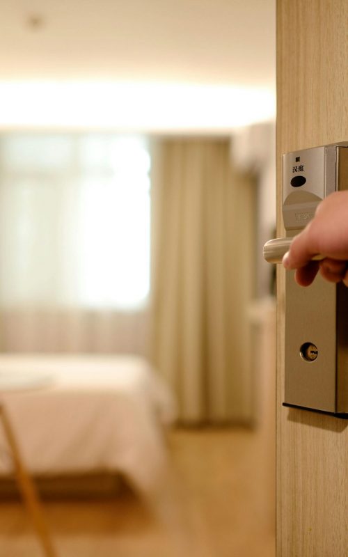 A soft-lit hotel room entrance, welcoming guests with luxury appeal and comfort.